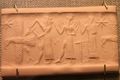 Oriental Institute Museum. God with ax attacks eagle while Shamash and Worshipper stand behind (5948336437).jpeg